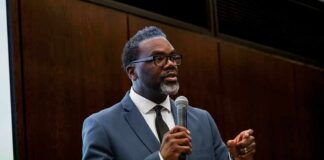 Man in a suit speaking into a microphone