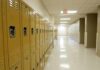 Row of yellow school lockers in an empty hallway
