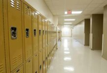 Row of yellow school lockers in an empty hallway