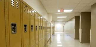 Row of yellow school lockers in an empty hallway