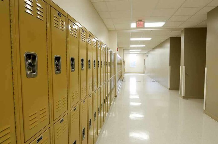 Row of yellow school lockers in an empty hallway