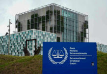Sovereignty Showdown: Hague vs. White House International Criminal Court building with sign in foreground.