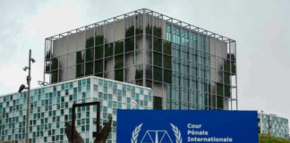 International Criminal Court building with sign in foreground.