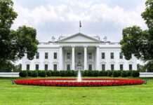 Behind The White House, She Fought Another Battle The White House with fountain and red flower bed