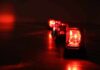 Trail Shutdown As Fire Jumps Ridges Row of red emergency beacons on a dark floor