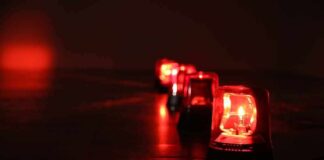 Row of red emergency beacons on a dark floor