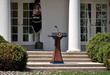 First Amendment Showdown – Lines Crossed? Podium with presidential seal in a garden colonnade