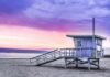 Quake Swarm Rattles L.A. – More Than 90 in ONE Day! Lifeguard tower on a sandy beach at sunset with colorful sky