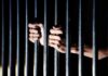 Equal Justice Shaken: Diddy Allegations Mount hands gripping prison bars