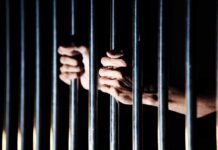 Equal Justice Shaken: Diddy Allegations Mount hands gripping prison bars
