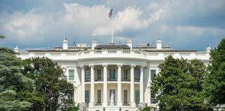 The White House north facade behind a black iron fence
