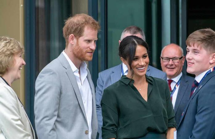 Prince Harry, Duke of Sussex, and Meghan, Duchess of Sussex speaking with attendees