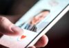 A Dating App Match Allegedly Became A Nightmare hand using a dating app on a smartphone