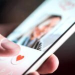 hand using a dating app on a smartphone