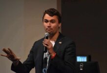 White House Honors, Crowd Erupts Anyway man speaking into a microphone on stage