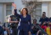 Detroit Dodge: Harris Keeps 2028 Open woman in navy suit waving at an outdoor event