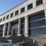 Modern office building with columns and reflective windows
