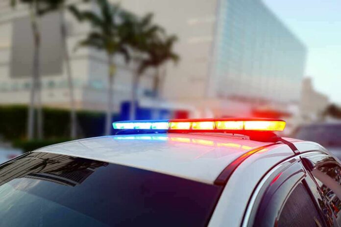 shutterstock_1436930477 Police car roof with flashing red and blue lights