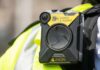 Warrants Tested by Explosive Raid Video Body-worn camera attached to a high-visibility vest