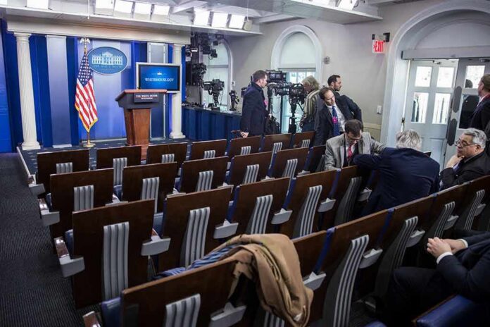 White House press briefing room with empty seats and cameras