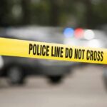 Torso In A Tote – Teen Bolts, Cops Move Yellow police line tape at a blurred street scene