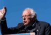 elderly man speaking at outdoor podium