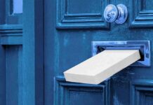 Their Cat Vanished. Then Came A Chilling Delivery White package halfway through a blue door mail slot
