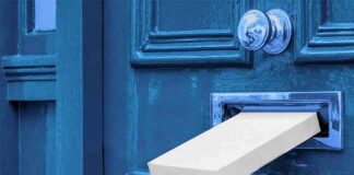 White package halfway through a blue door mail slot