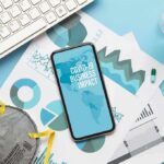 New Fauci Texts Reveal an Early Vaccine Debate Smartphone on business charts with mask, keyboard, pills, and hand sanitizer