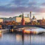 Kremlin complex by a river at sunset