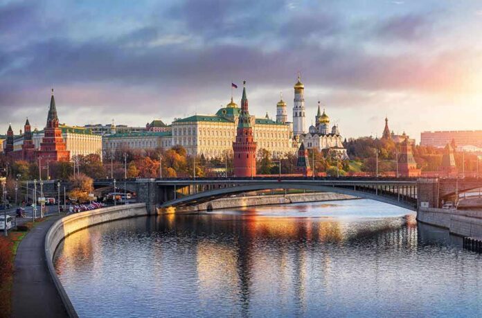 Kremlin complex by a river at sunset