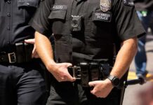 Police officers in black uniforms with duty belts