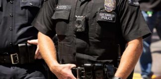 Police officers in black uniforms with duty belts