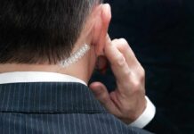 Secret Service Blindspot Exposed security agent with earpiece touching ear