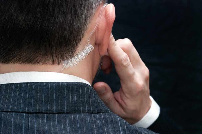 shutterstock_172646543 security agent with earpiece touching ear