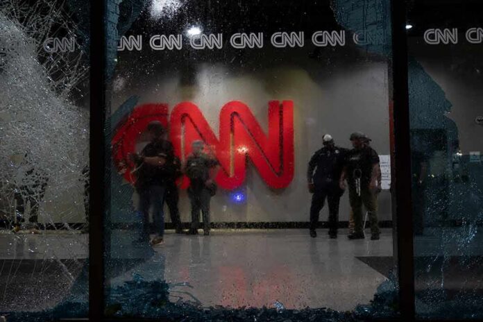 shutterstock_1744492979 police officers inside lobby seen through shattered glass window