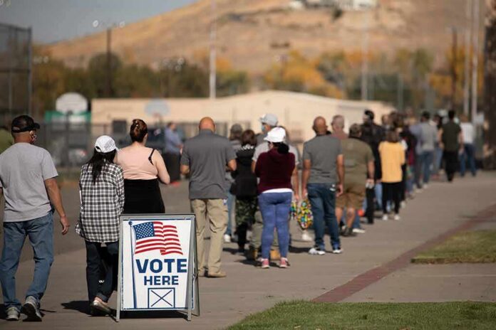 shutterstock_1847496532 voters standing in a long line outside a polling place