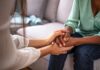 A Marine’s Death Inspires a Mission for Veterans Two people holding hands on a couch