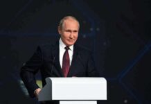 Power Grid Showdown: Will Putin Blink? person in suit speaking at a podium