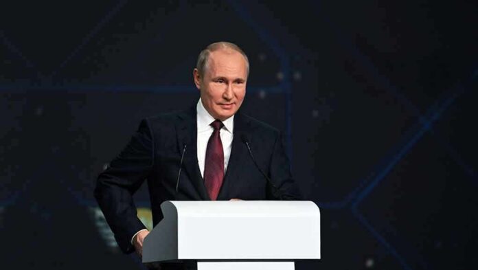 person in suit speaking at a podium