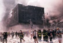 Emergency responders and civilians amidst debris at a disaster site