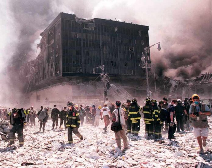 Emergency responders and civilians amidst debris at a disaster site