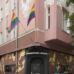 Pink corner building with rainbow flags