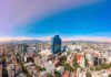 Global Heat Kill Count Stuns Researchers City skyline with tall blue-glass tower at center under clear sky