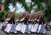 Ryan Hewitt and Bear Pascoe marching with a military honor guard in a parade