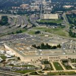 Aerial view of a large five-sided government building with surrounding highways