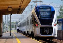 Modern passenger train arriving at a station platform