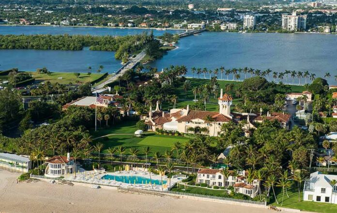 shutterstock_518463952 Aerial view of a waterfront estate with pool, lawns, and palm trees
