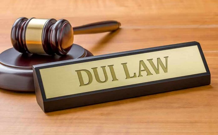shutterstock_584202865 Judge's gavel beside a nameplate on a wooden desk