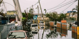 Flooded urban street with abandoned cars and downed power lines